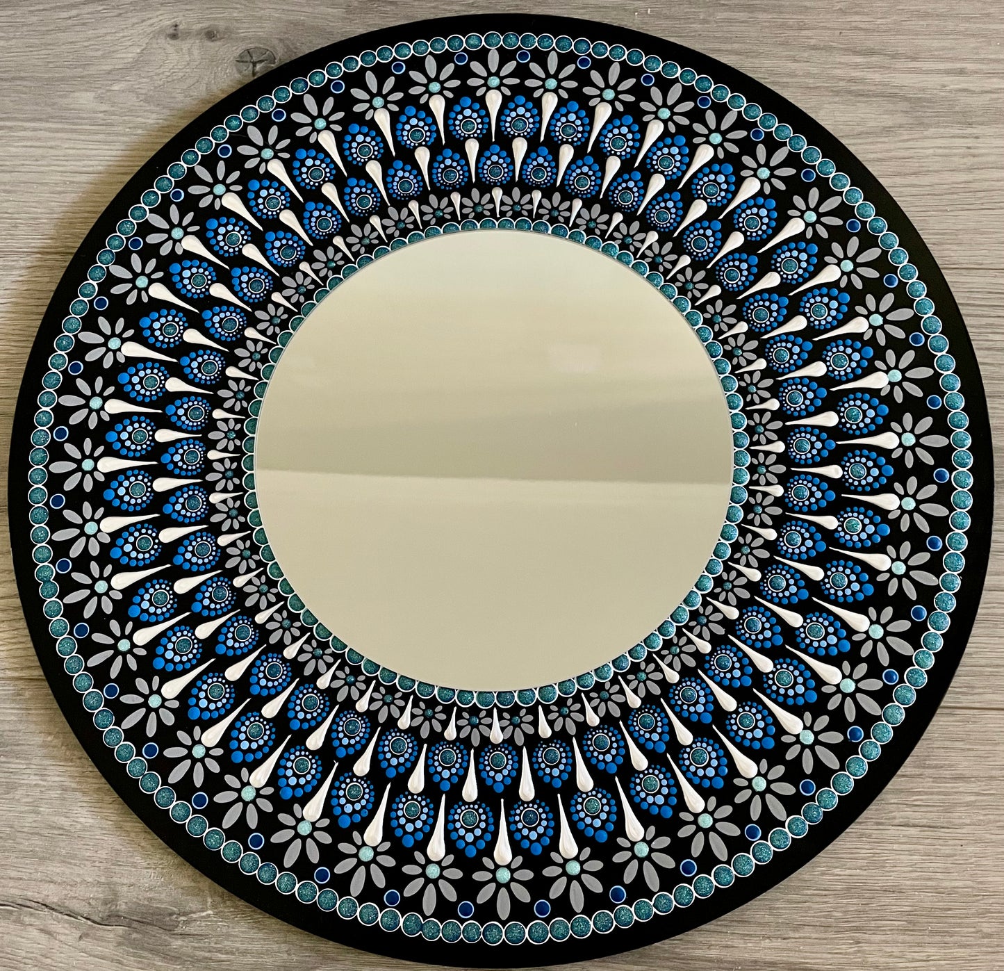 Hand painted 16 inch wood round with mirror in the center. 