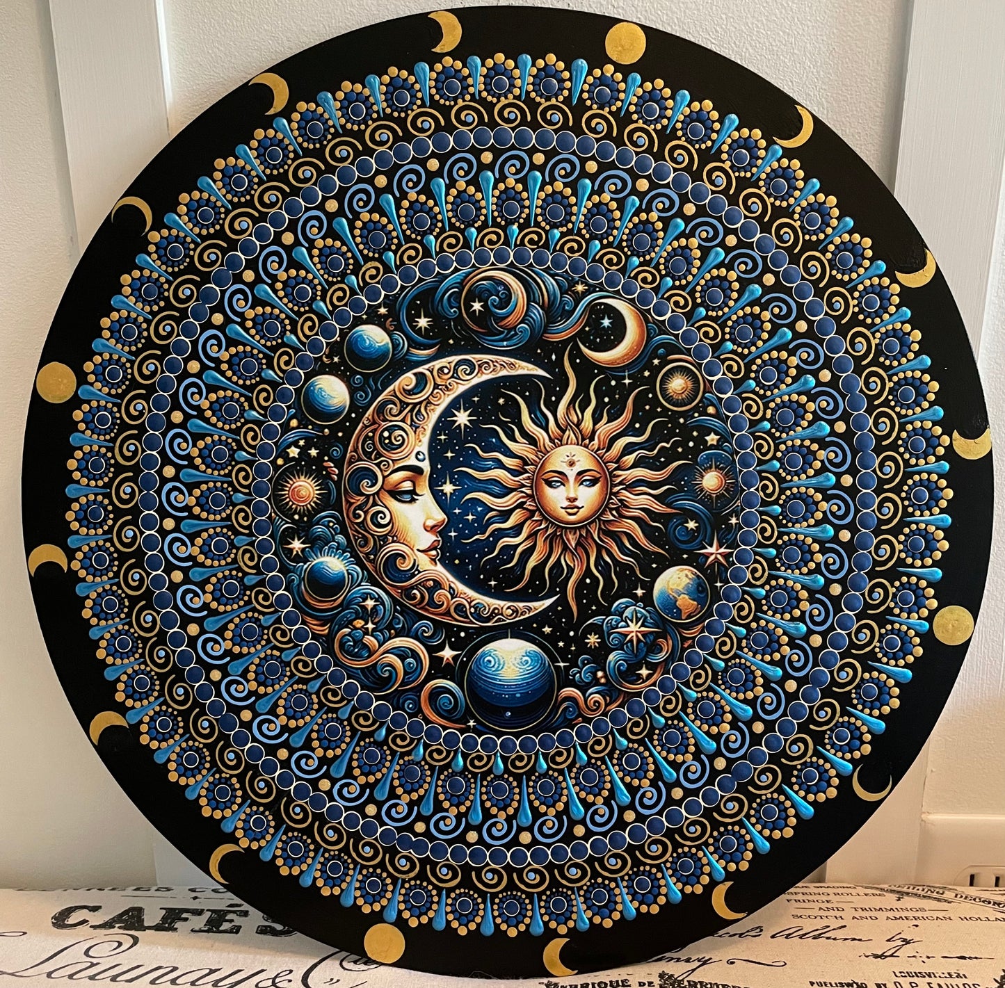 Handpainted sun and moon plaque on 16 inch wood round.
