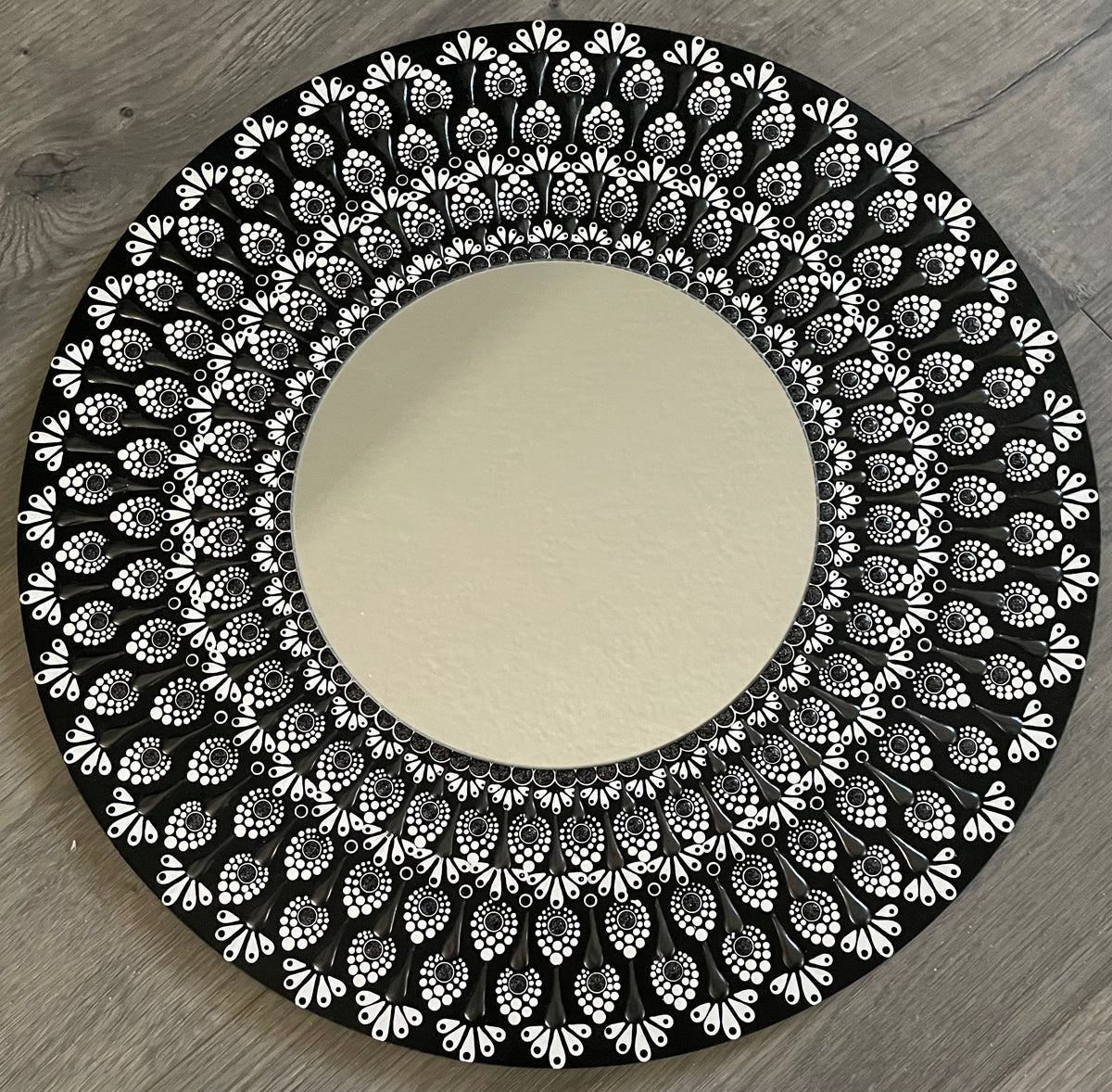Hand painted black-and-white mirror plaque on a 16 inch wood round