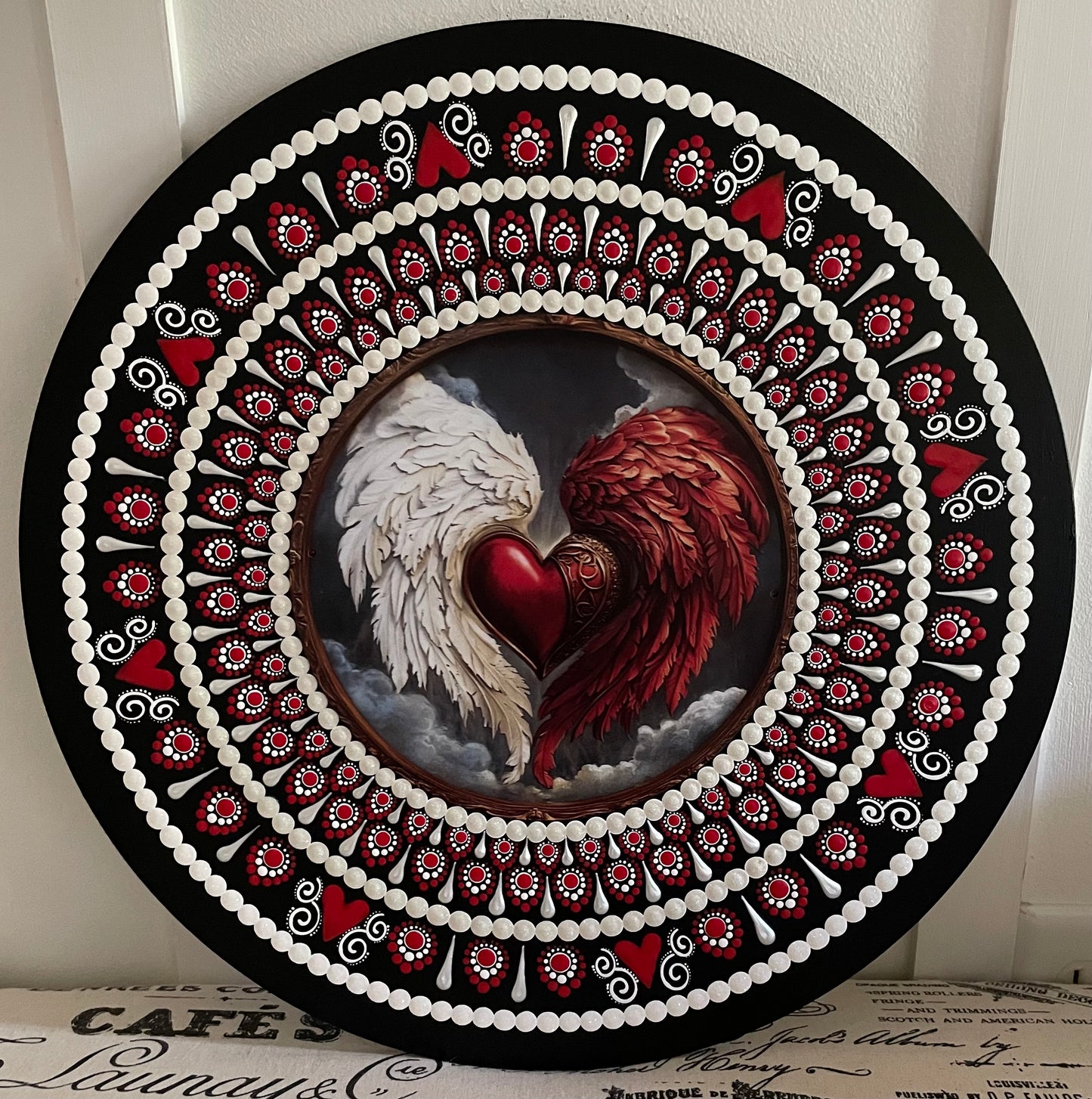 Handpainted red and white angel wings plaque on a 16 inch wood round