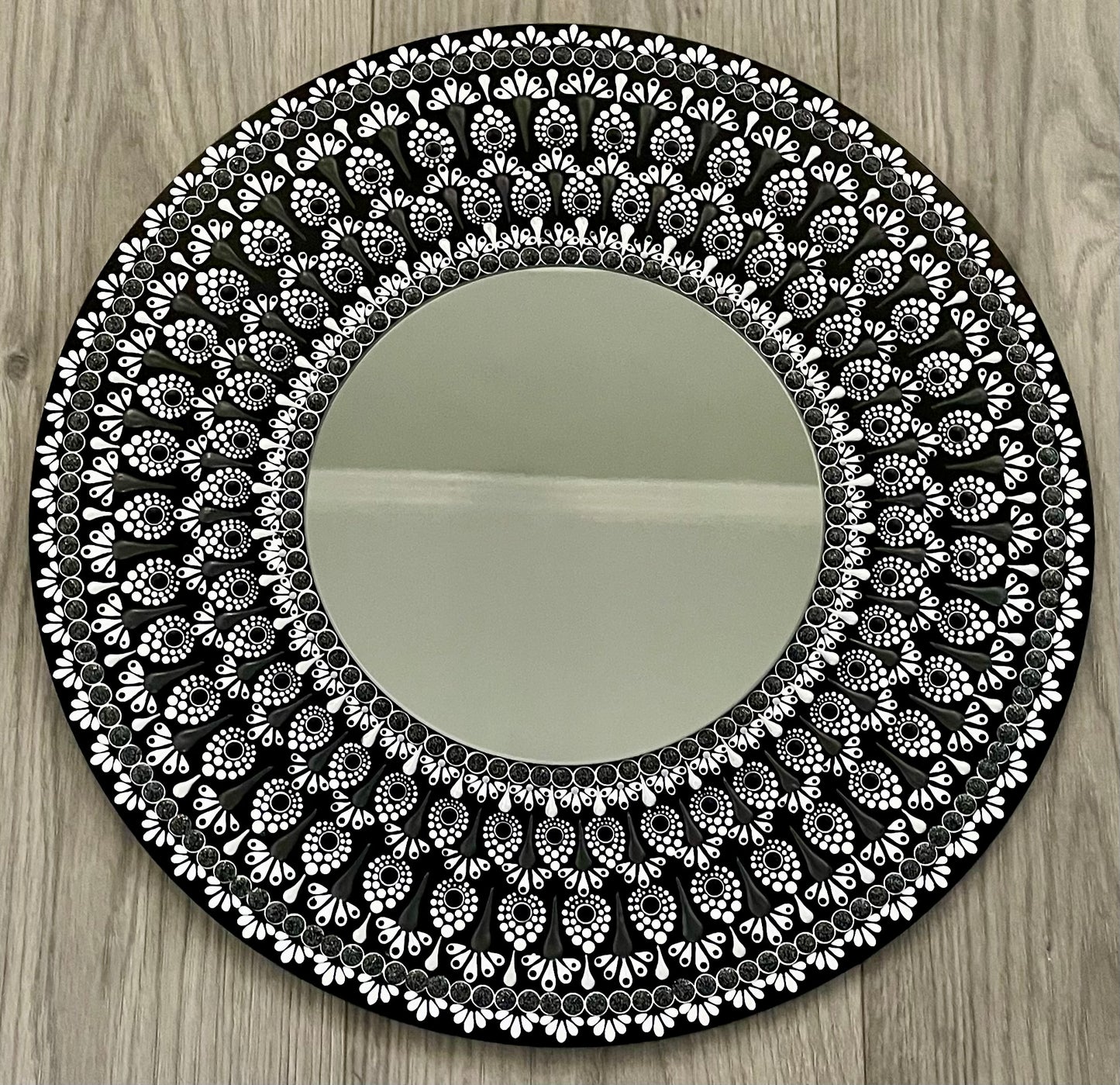 Hand painted black and white 16 inch round plaque with an 8 inch mirror in the center